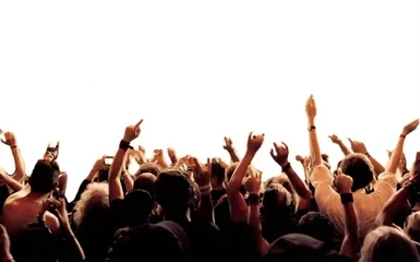 A concert crowd with raised arms