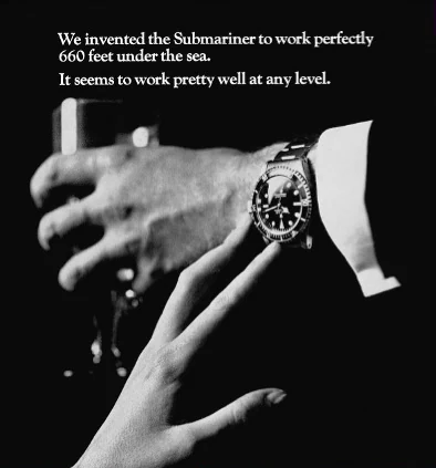 Black and white advertisement of a diver's watch on a wrist