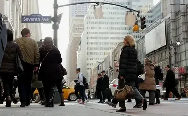 Pedestrians crossing a busy New York street