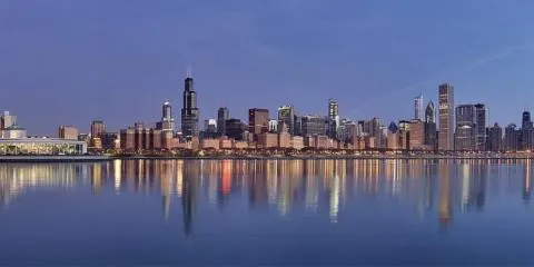Chicago skyline reflected in Lake Michigan at dawn